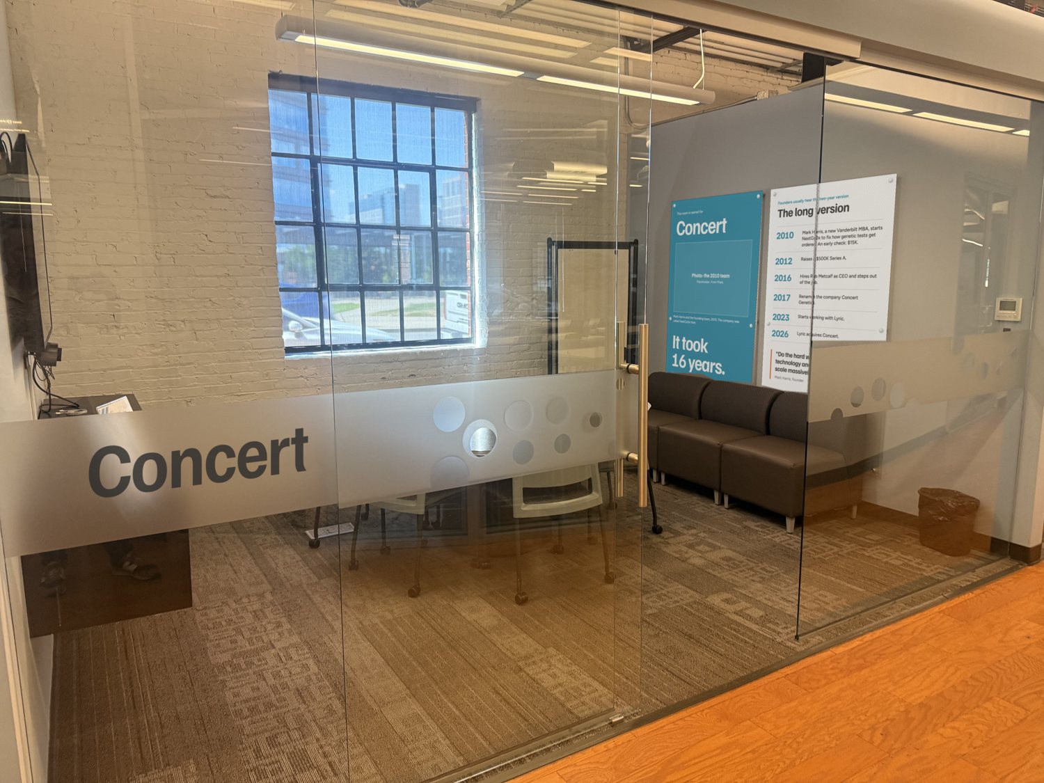 Hallway view of the room with Concert lettering on the frosted glass band and two story panels visible on the far wall.