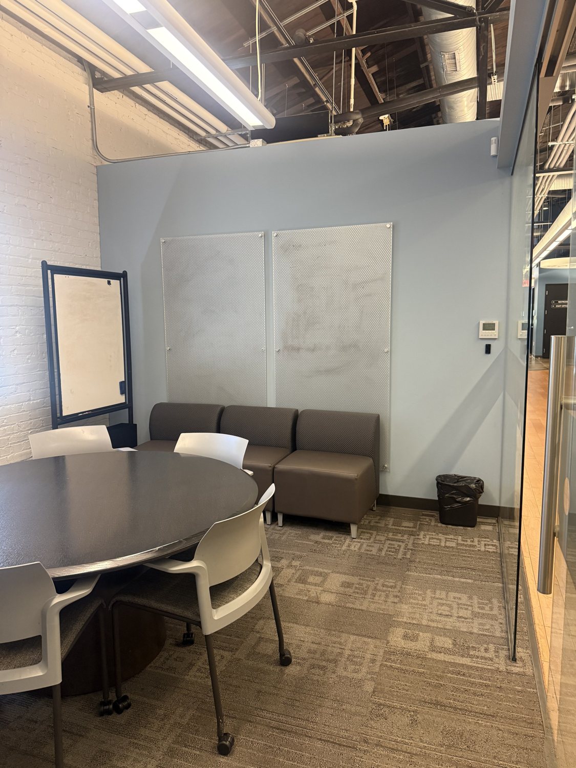 The same wall today with two blank perforated metal panels.